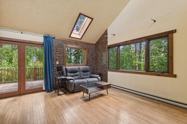 interior space with a skylight and a baseboard heating unit