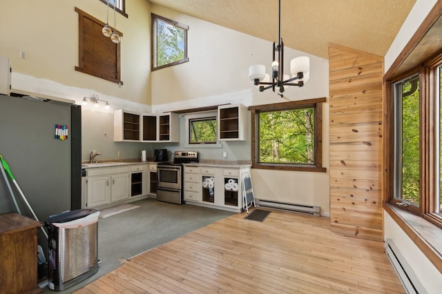 kitchen with baseboard heating, stainless steel electric range, high vaulted ceiling, and open shelves