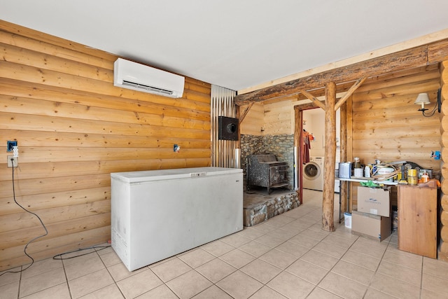 635 Lore Lake Rd, Kalispell, MT 59901 - interior space featuring washer / clothes dryer, a wall mounted air conditioner, log walls, and light tile patterned floors