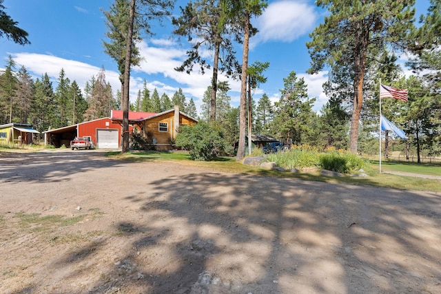 635 Lore Lake Rd, Kalispell, MT 59901 - view of front facade featuring driveway, an attached garage, and a carport