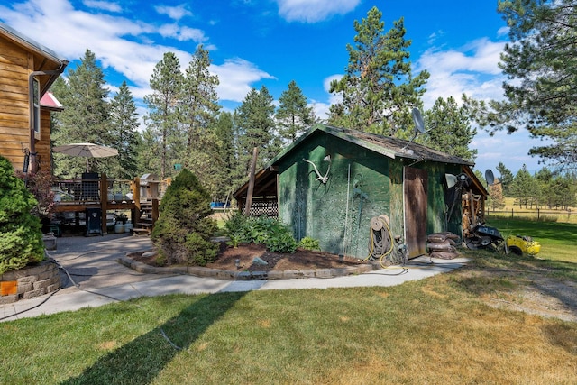 635 Lore Lake Rd, Kalispell, MT 59901 - view of home's exterior featuring a deck and a yard