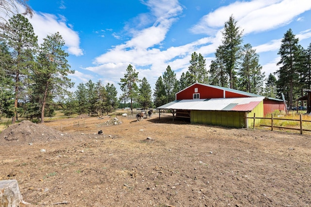 635 Lore Lake Rd, Kalispell, MT 59901 - view of yard featuring an outbuilding, a pole building, a detached garage, and fence