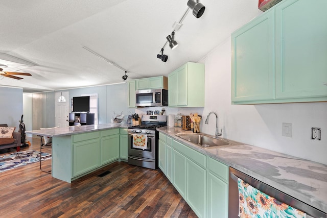 635 Lore Lake Rd, Kalispell, MT 59901 - kitchen with dark wood-style floors, a peninsula, stainless steel appliances, a kitchen bar, and a sink