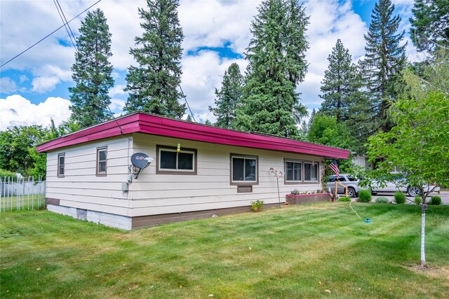 rear view of property featuring a yard