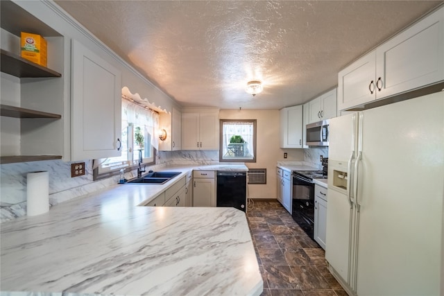 kitchen with open shelves, light countertops, a sink, and black appliances