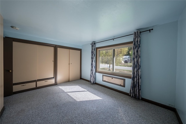unfurnished bedroom with carpet and baseboards