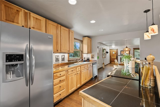 908 10th St, Whitefish, MT 59937 - kitchen with stainless steel appliances, dark wood finished floors, recessed lighting, light brown cabinets, and hanging light fixtures
