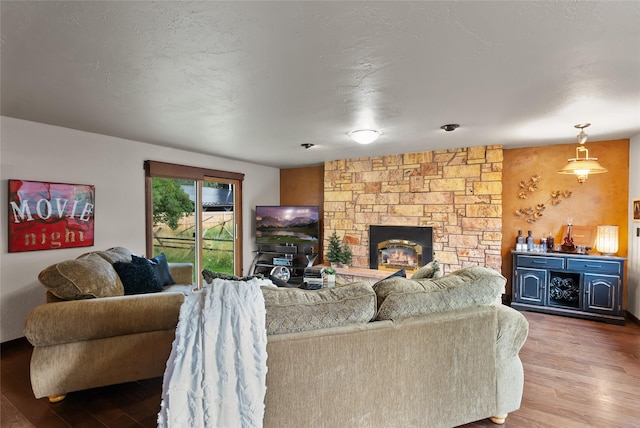 908 10th St, Whitefish, MT 59937 - living room with wood finished floors and a stone fireplace