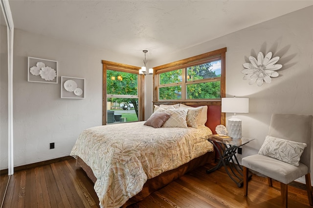 908 10th St, Whitefish, MT 59937 - bedroom with wood-type flooring and a chandelier