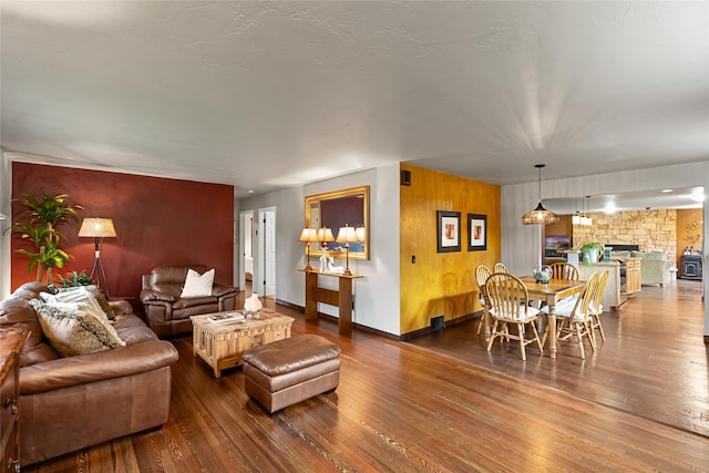 908 10th St, Whitefish, MT 59937 - living room featuring an accent wall, dark wood-style floors, and a fireplace
