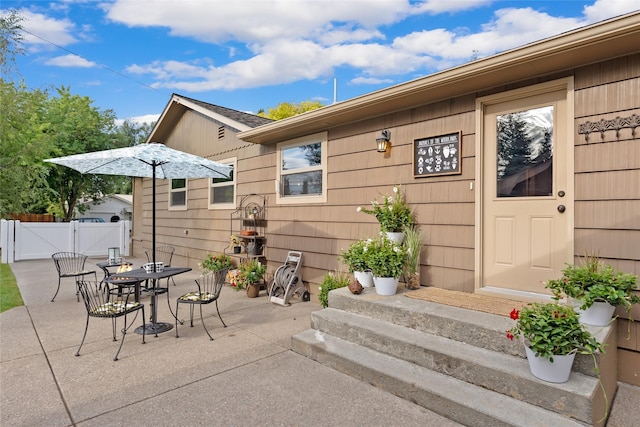 908 10th St, Whitefish, MT 59937 - view of patio / terrace with outdoor dining area and a gate