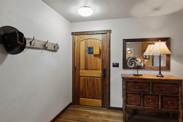 908 10th St, Whitefish, MT 59937 - doorway featuring wood finished floors and baseboards