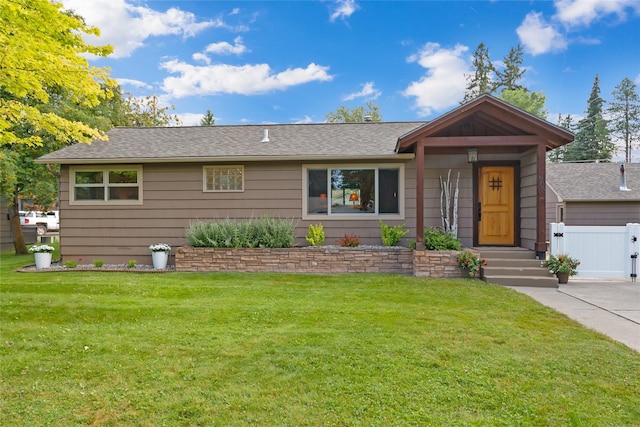 908 10th St, Whitefish, MT 59937 - ranch-style house with a shingled roof and a gate