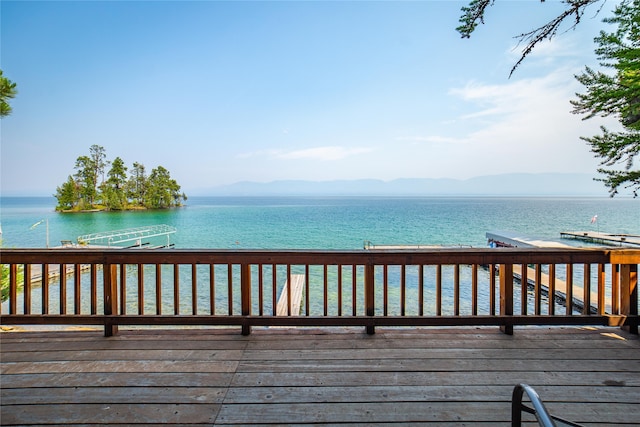 wooden deck featuring a water view