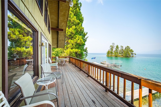 wooden terrace featuring a water view