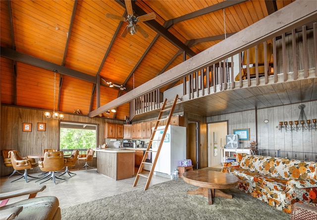 tiled living room featuring wooden ceiling, ceiling fan with notable chandelier, high vaulted ceiling, beamed ceiling, and wood walls