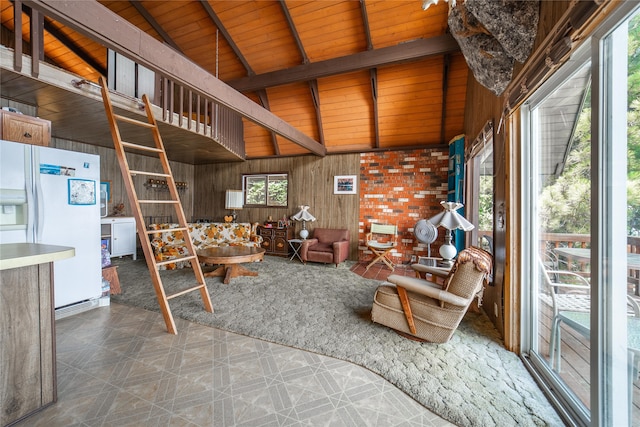 living room with vaulted ceiling with beams, wooden ceiling, wooden walls, and a wealth of natural light