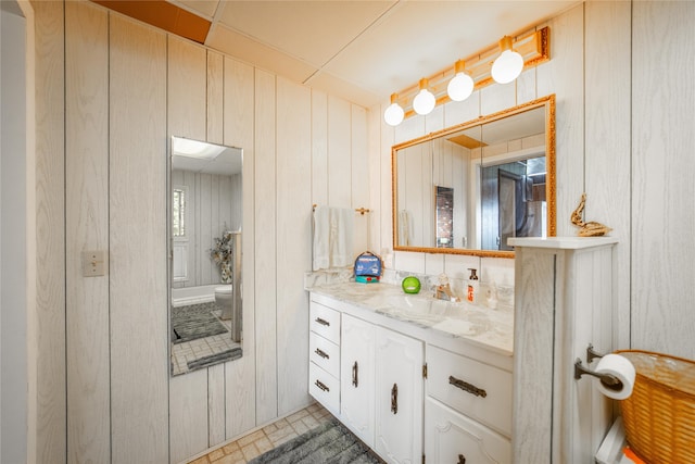 bathroom with tile patterned flooring, toilet, and vanity