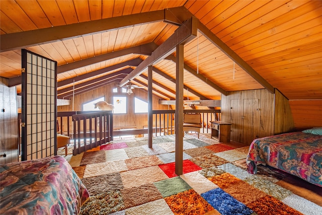 bedroom with wood walls, lofted ceiling with beams, and wooden ceiling