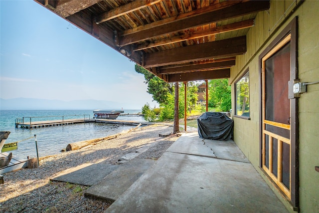 view of patio / terrace featuring a dock and a water view