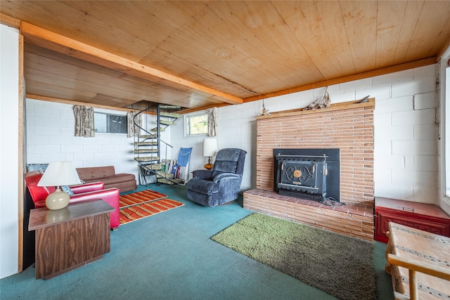 carpeted living room with a wood stove, a fireplace, and wood ceiling