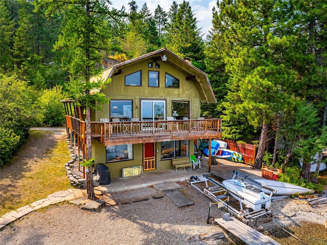 rear view of property featuring a deck