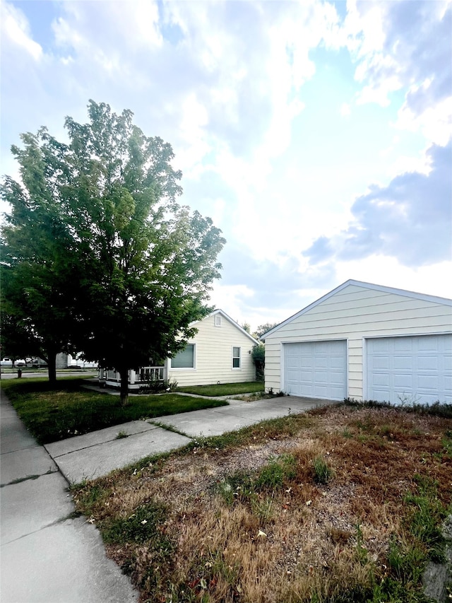 exterior space with a garage and an outbuilding