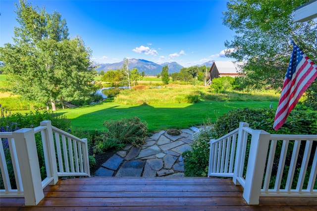 view of yard with a deck with mountain view