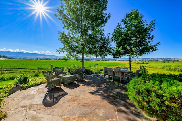 view of patio with a mountain view and a rural view