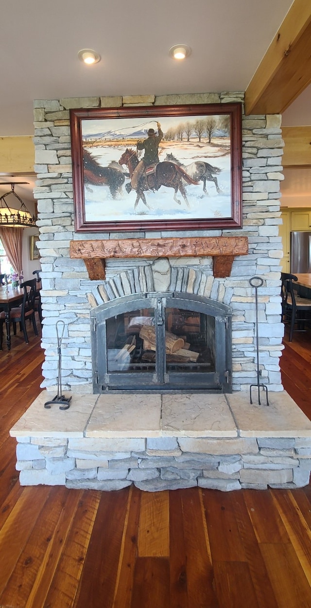 room details featuring hardwood / wood-style floors and a stone fireplace