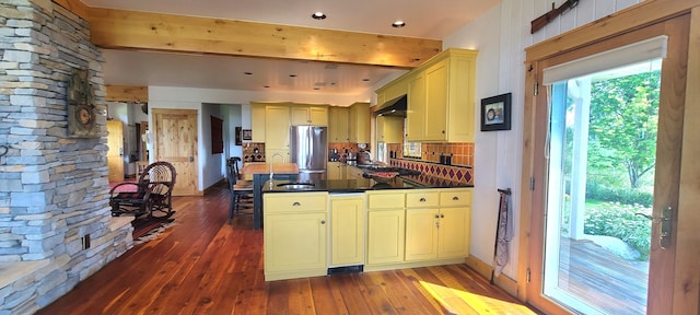 kitchen featuring stainless steel fridge, dark hardwood / wood-style flooring, custom range hood, and sink