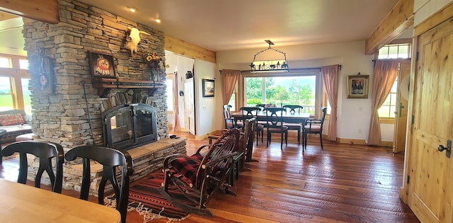 living room with a fireplace, a wealth of natural light, and dark hardwood / wood-style floors