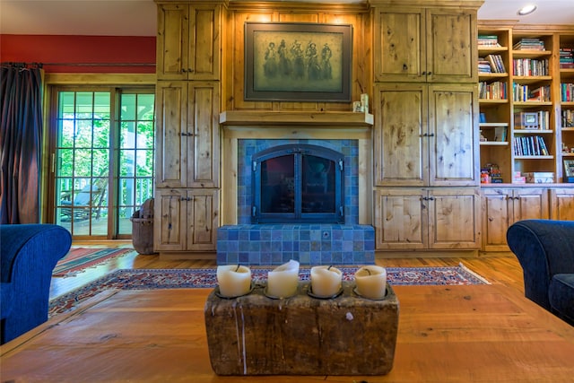 living room with hardwood / wood-style flooring and a fireplace