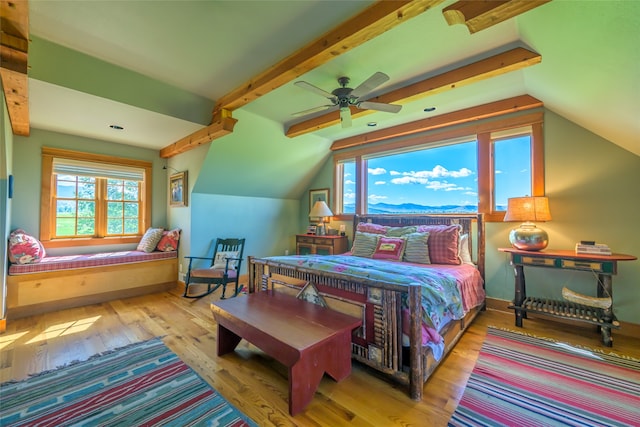 bedroom featuring hardwood / wood-style floors, ceiling fan, and lofted ceiling with beams