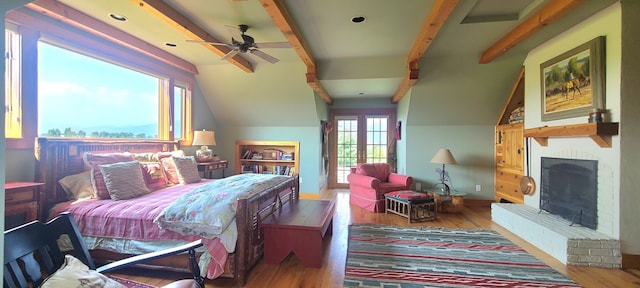 bedroom with a fireplace, hardwood / wood-style flooring, ceiling fan, and vaulted ceiling with beams