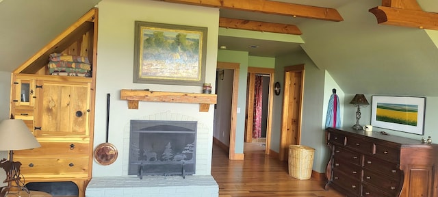 interior space with a fireplace, lofted ceiling with beams, and dark hardwood / wood-style flooring