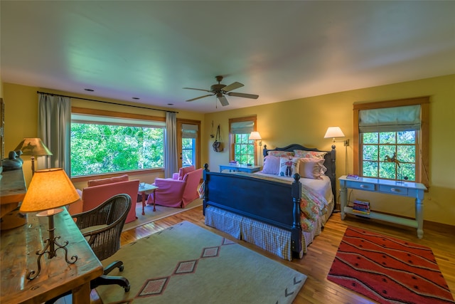 bedroom featuring multiple windows, ceiling fan, and hardwood / wood-style floors