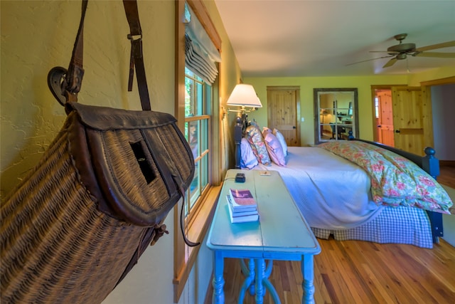 bedroom with ceiling fan and wood-type flooring