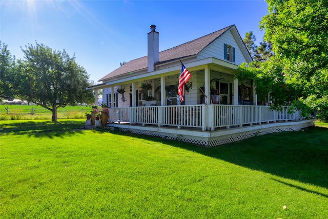 back of house with a yard and covered porch