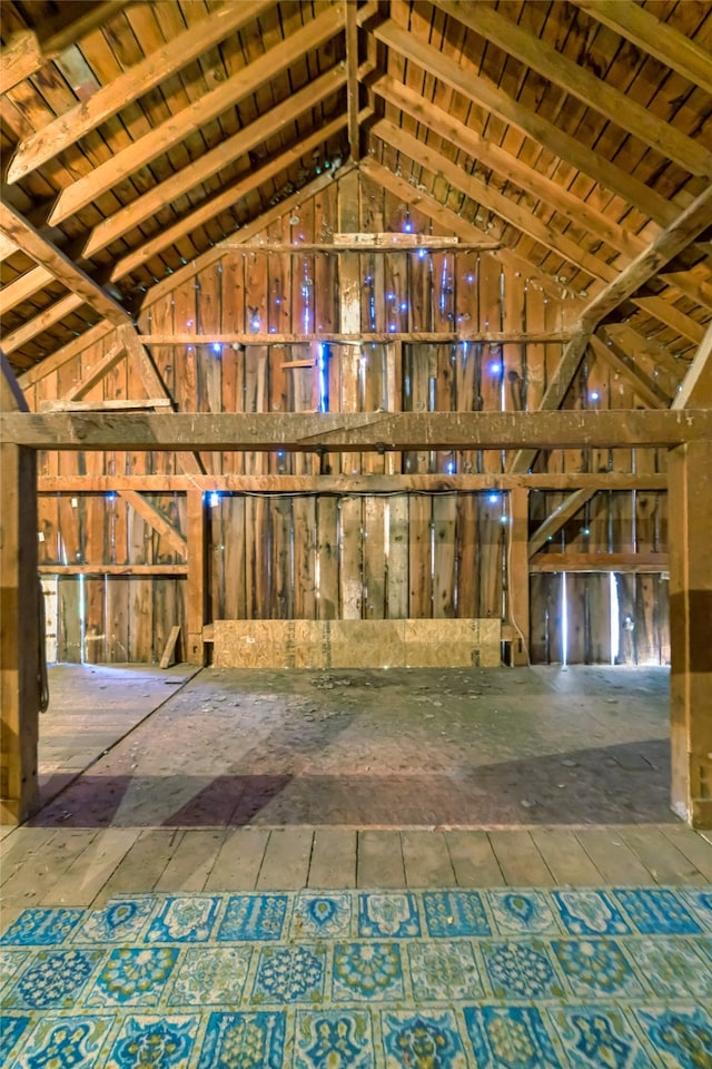 miscellaneous room featuring high vaulted ceiling