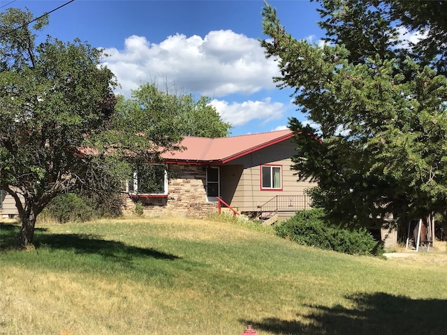 view of home's exterior with a yard