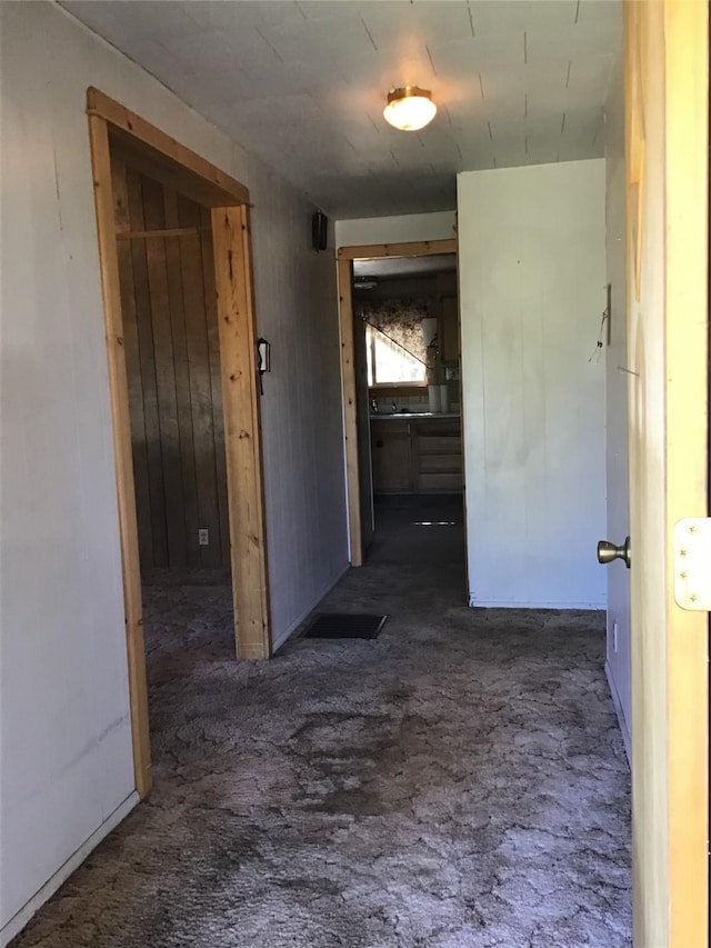 corridor with dark colored carpet