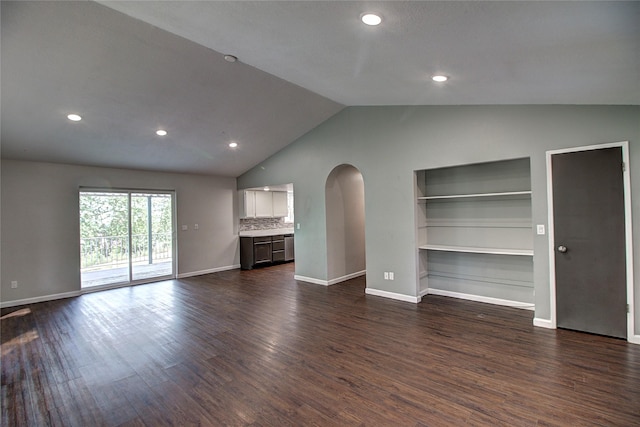 unfurnished living room featuring lofted ceiling, baseboards, arched walkways, and dark wood-type flooring