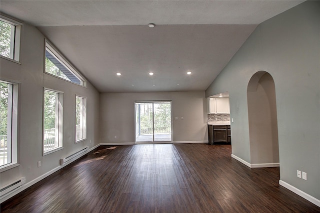 unfurnished living room featuring arched walkways, baseboards, baseboard heating, and dark wood-type flooring