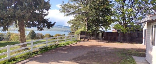 view of yard featuring fence and a mountain view