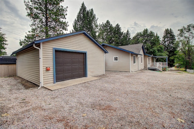 detached garage with gravel driveway