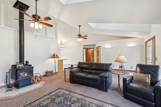 living room featuring a wood stove, carpet flooring, high vaulted ceiling, and ceiling fan