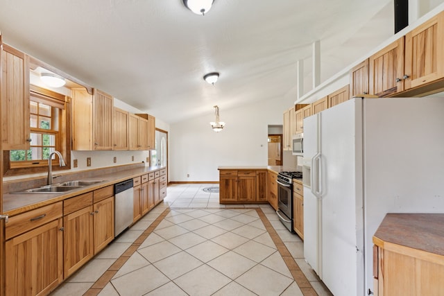 kitchen with stainless steel appliances, pendant lighting, sink, lofted ceiling, and light tile patterned floors