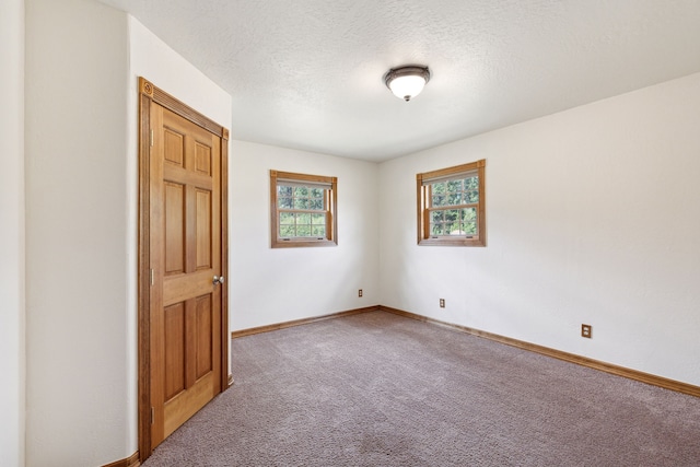 unfurnished bedroom featuring carpet and a textured ceiling