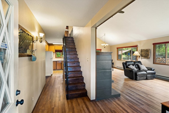 159 Sylvan Dr, Bigfork, MT 59911 - staircase featuring wood finished floors, baseboard heating, and a chandelier